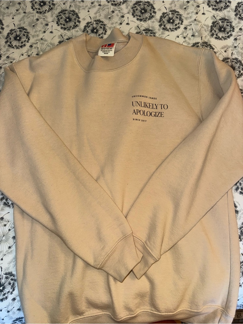 Uncommon James Cream Crewneck Sweatshirt with 'Unlikely To Apologize' Print
